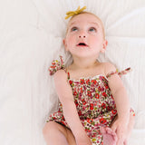 The Smocked Onesie in Poppy Floral