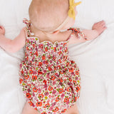 The Smocked Onesie in Poppy Floral