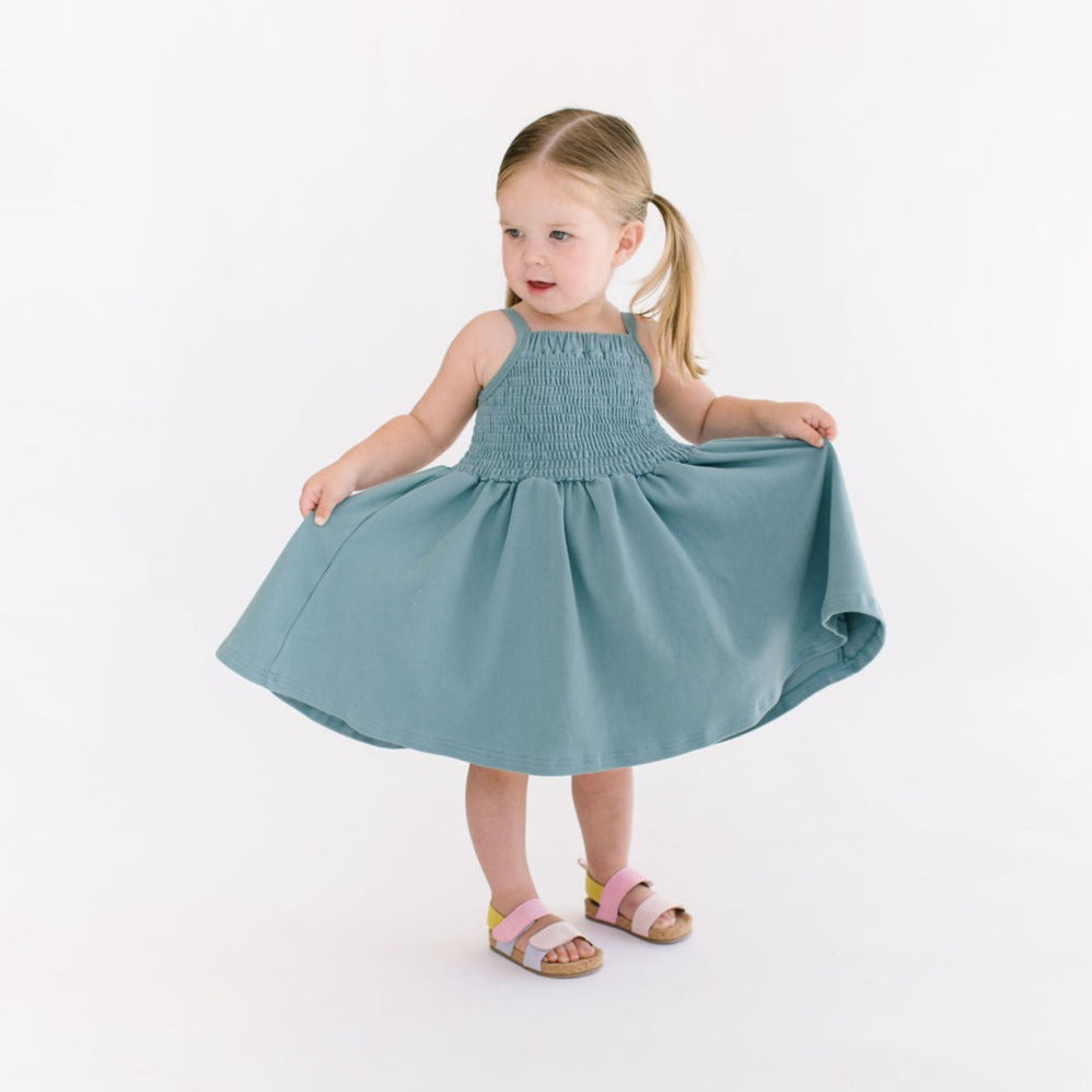 THE BABY SMOCKED DRESS IN AEGEAN BLUE