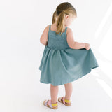 THE BABY SMOCKED DRESS IN AEGEAN BLUE