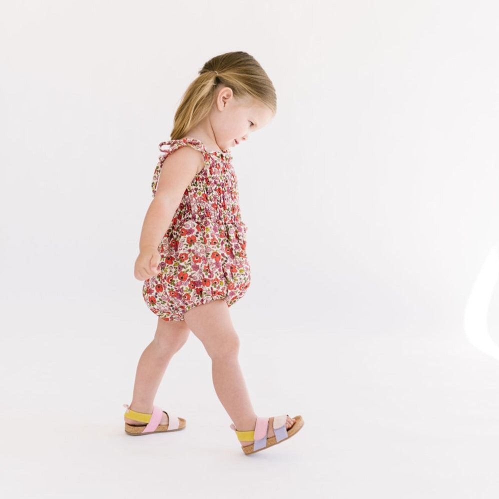 THE SMOCKED ONESIE IN POPPY FLORAL