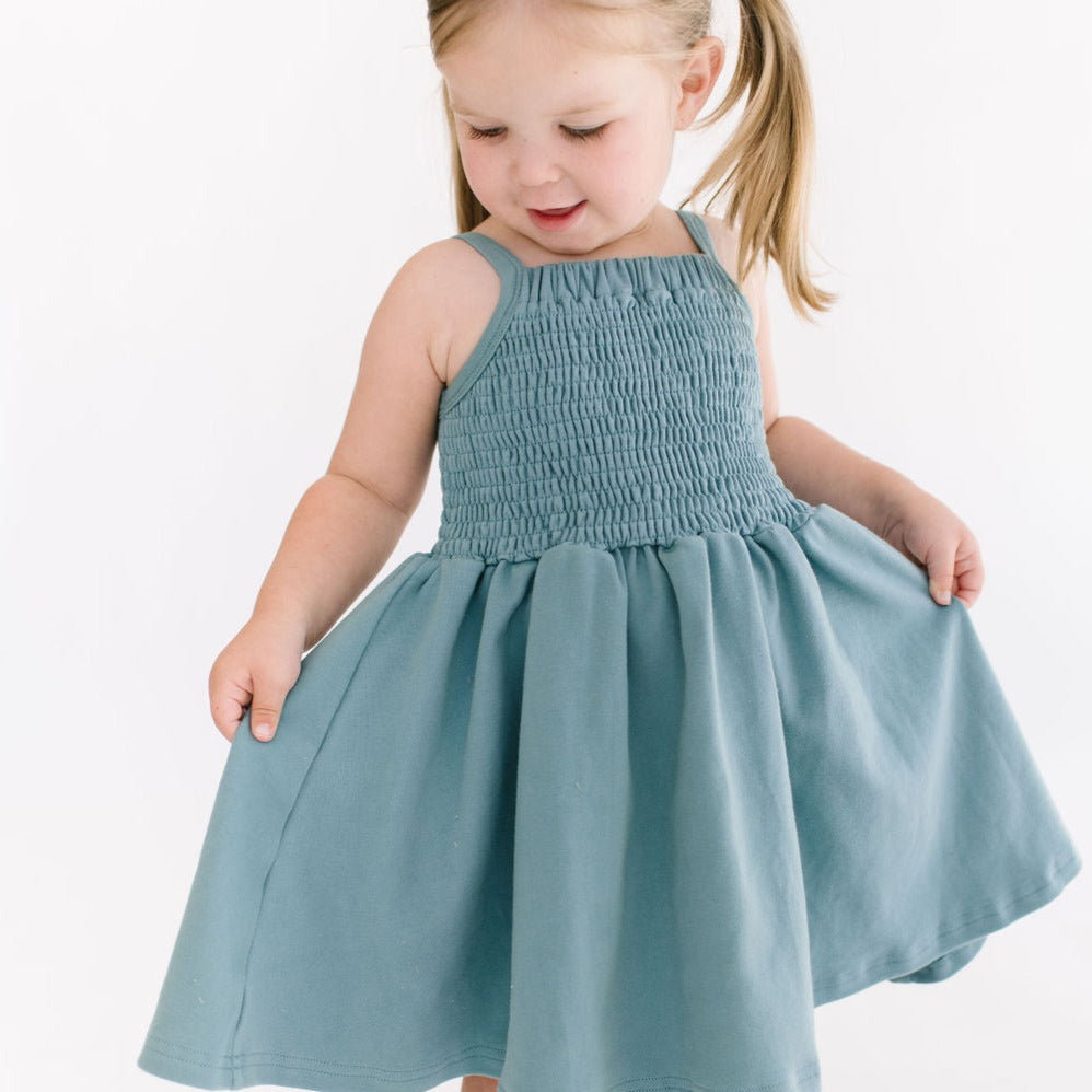 THE BABY SMOCKED DRESS IN AEGEAN BLUE