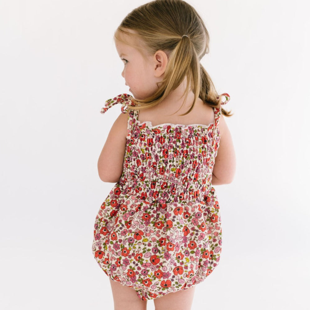 THE SMOCKED ONESIE IN POPPY FLORAL