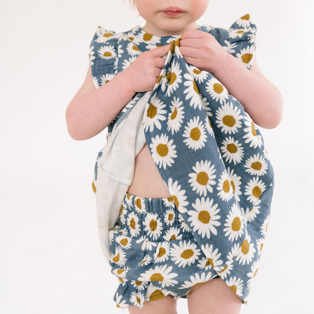 THE INFANT BLOOMER IN DAISIES