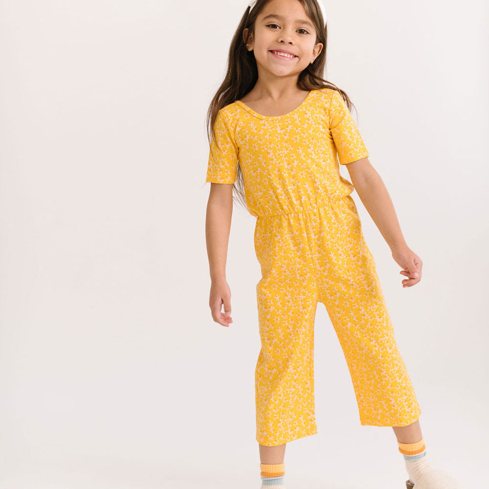 THE SHORT SLEEVE WIDE LEG JUMPSUIT IN ZINGY PETALS