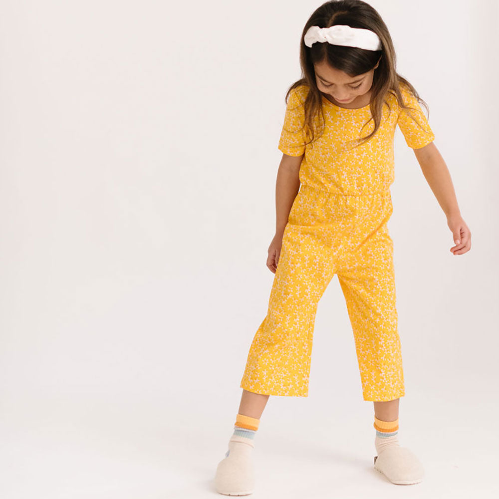 THE SHORT SLEEVE WIDE LEG JUMPSUIT IN ZINGY PETALS